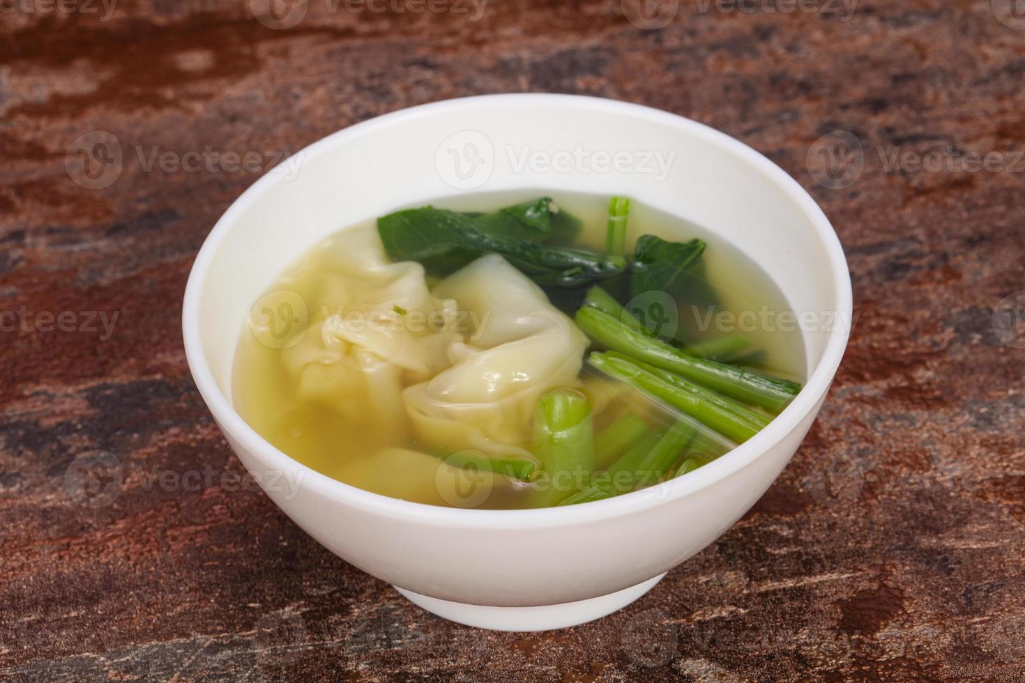 Asian traditional Wonton soup with herbs photo