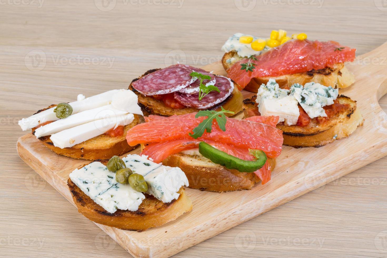 Tapas with cheese, salami and salmon photo