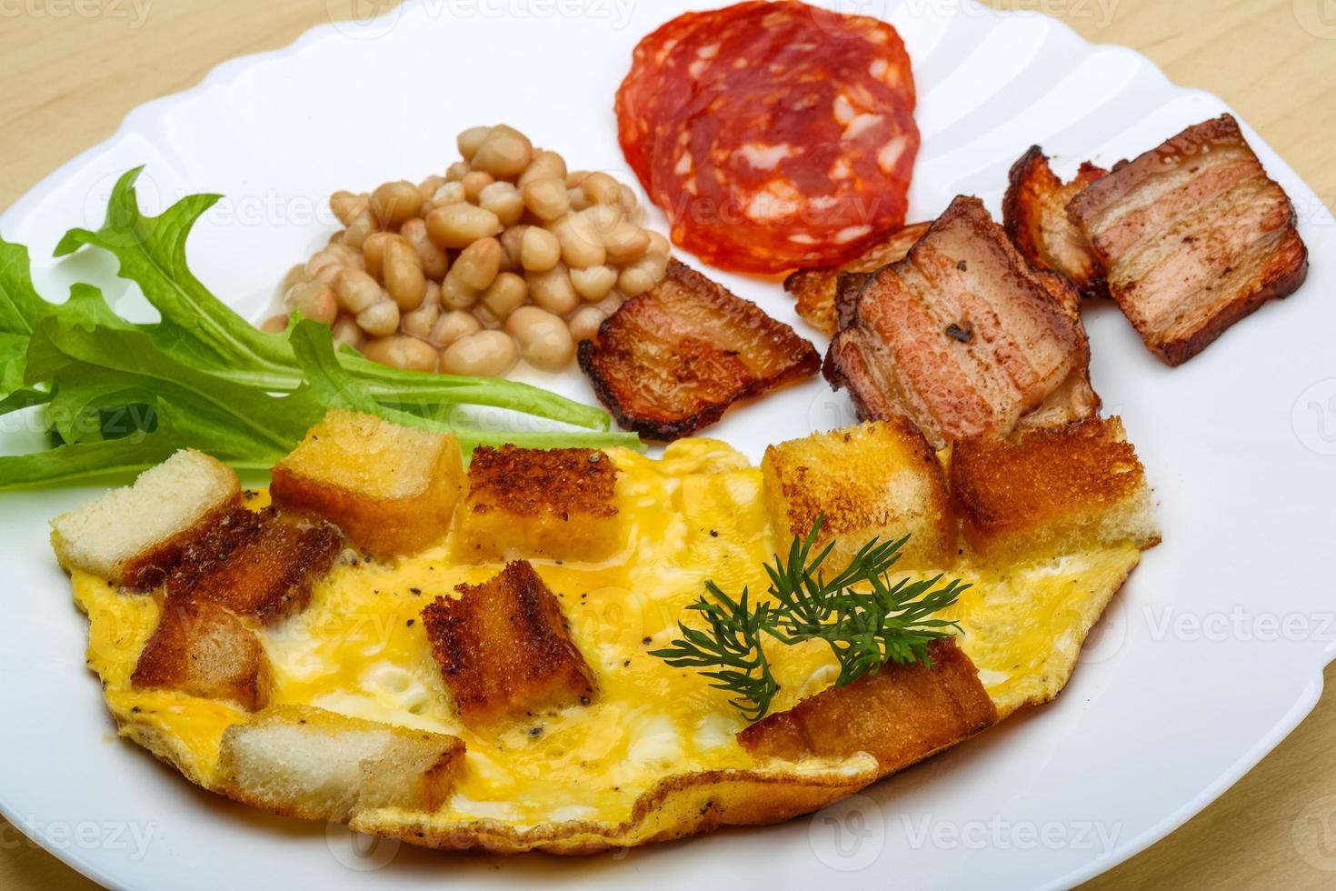 Breakfast with eggs, bacon and beans photo