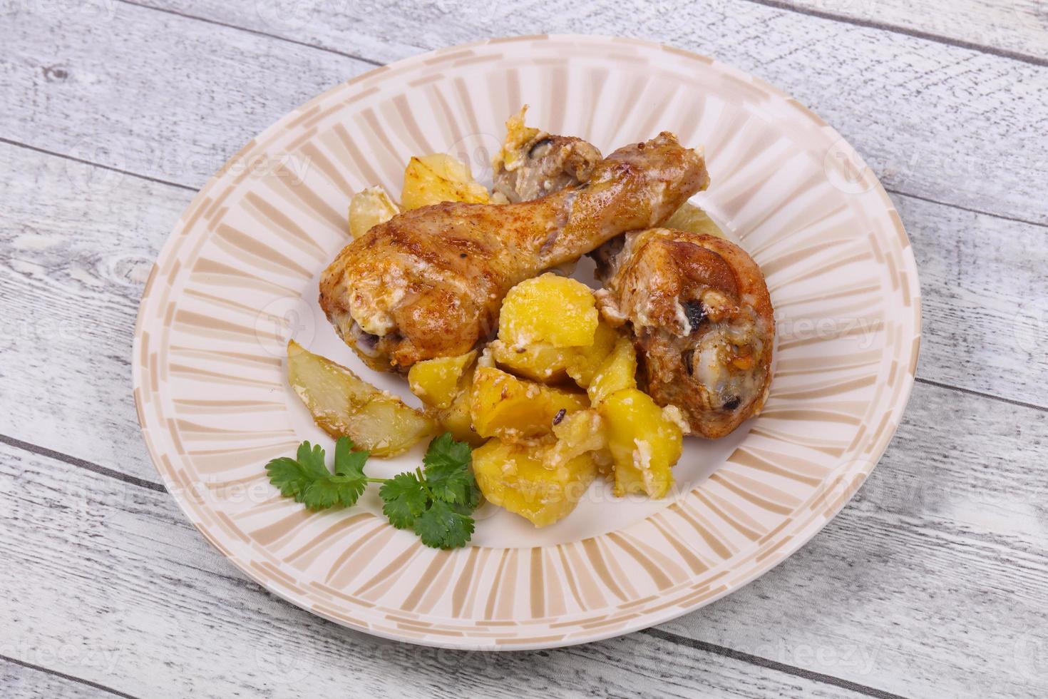 Roasted chicken legs with potato photo