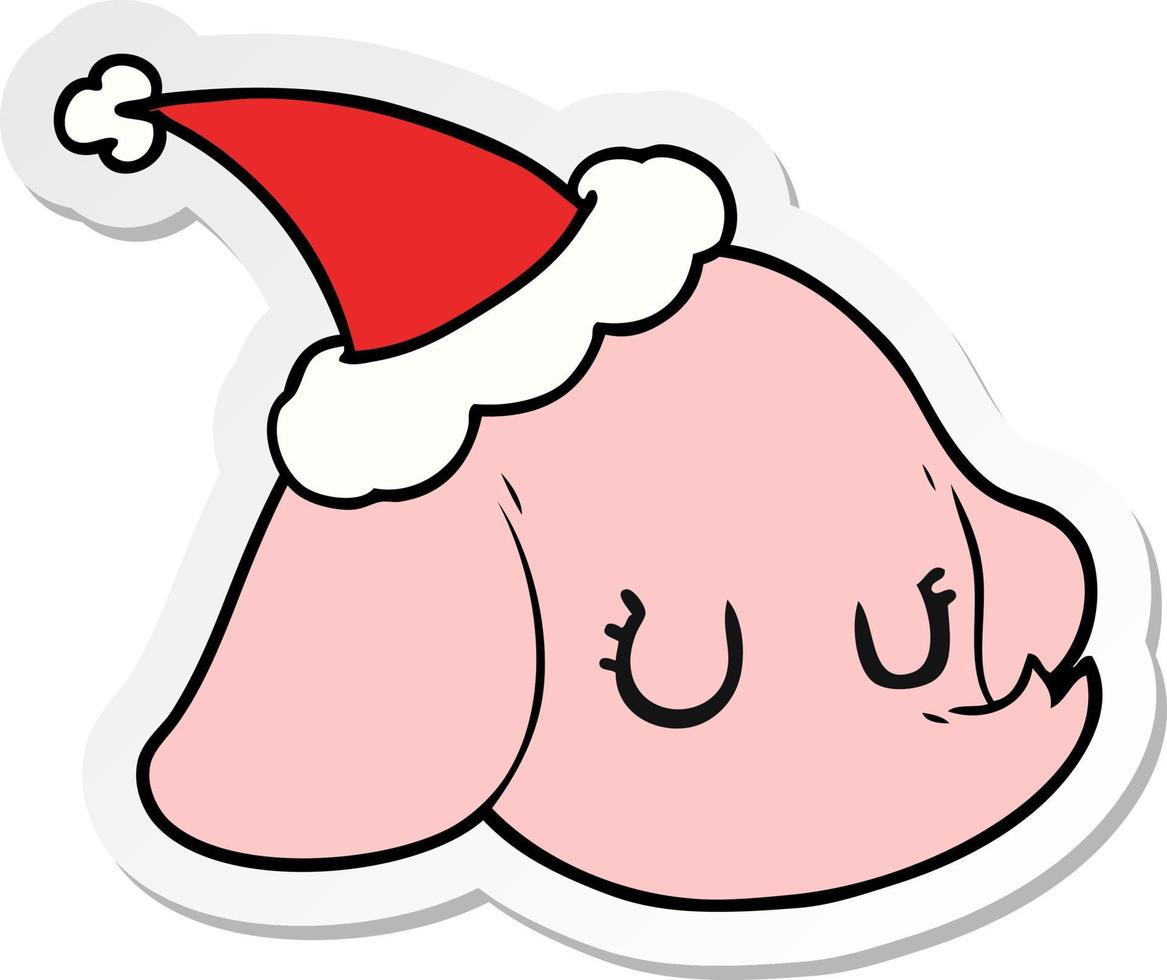 sticker cartoon of a elephant face wearing santa hat vector