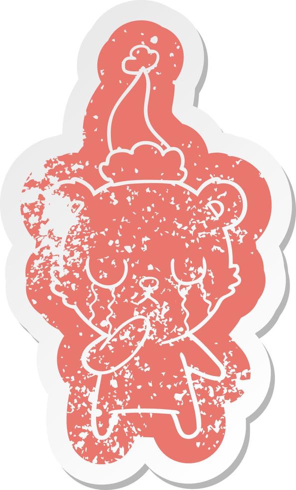 crying polar bear cartoon distressed sticker of a wearing santa hat vector