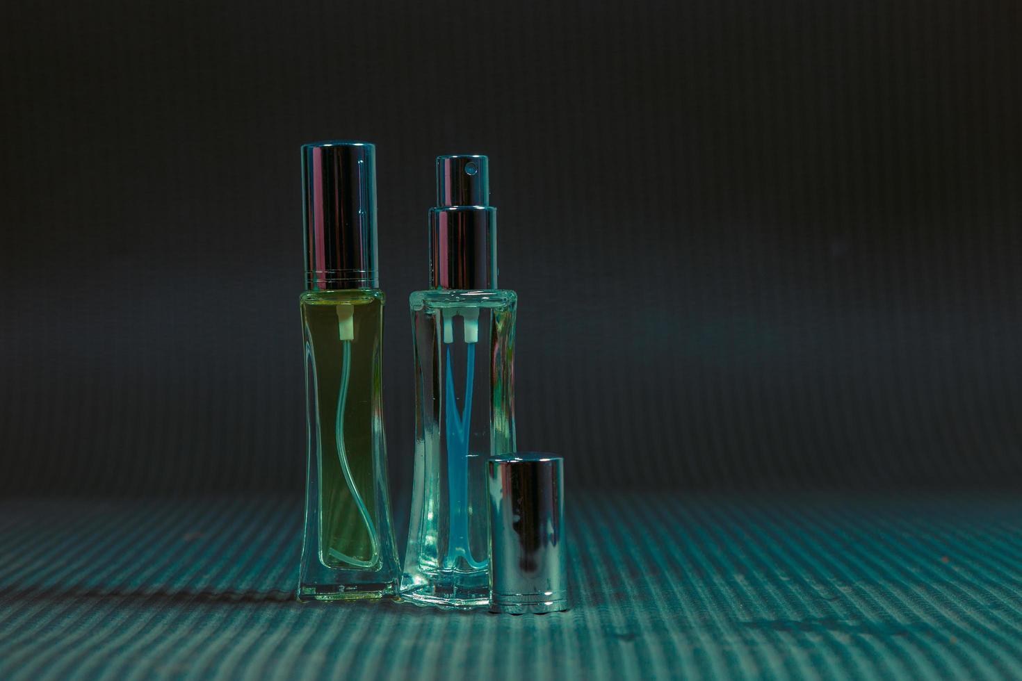 frasco de perfume sobre la mesa, fondo negro foto