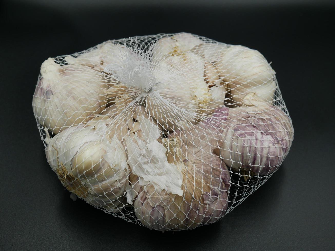 Garlic for sale has cladding material. photo