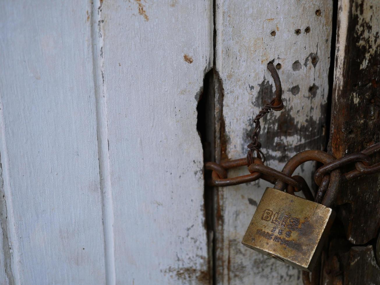 An old wooden door with a locking key. photo