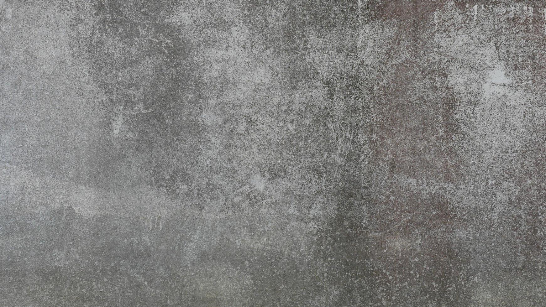 The old cement wall was weathered, the surface was scratched, the surface was scratched and damaged. For a mysterious retro-conservative background. photo