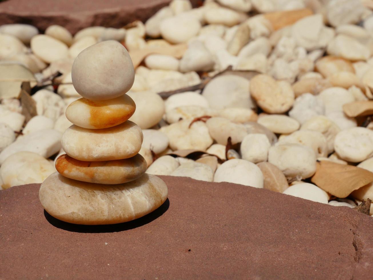 The Balance Stones are stacked as pyramids in a soft natural bokeh background, representing the calm philosophical concept of Jainism's wellness. photo