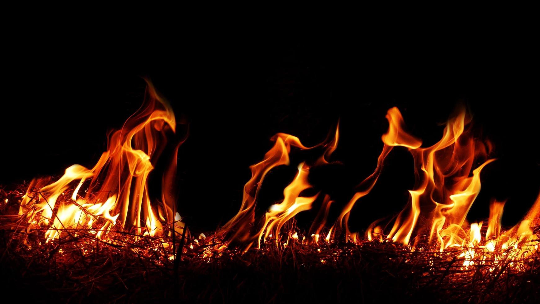 Haystack fires at night in arid areas The ash erupted and the wind was very dangerous. ashes red as hell. photo