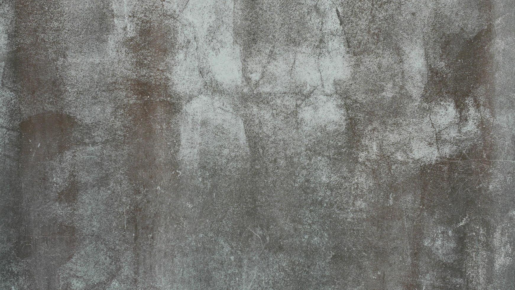 The old cement wall was weathered, the surface was scratched, the surface was scratched and damaged. For a mysterious retro-conservative background. photo