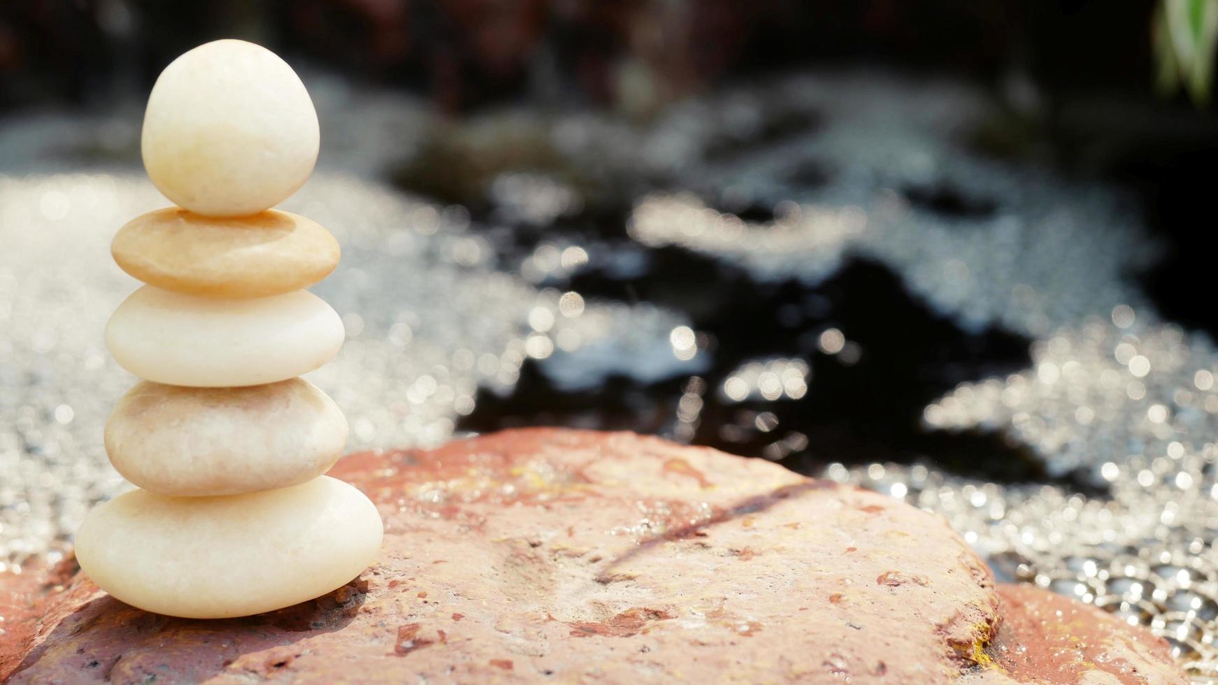 The Balance Stones are stacked as pyramids in a soft natural bokeh background, representing the calm philosophical concept of Jainism's wellness. photo