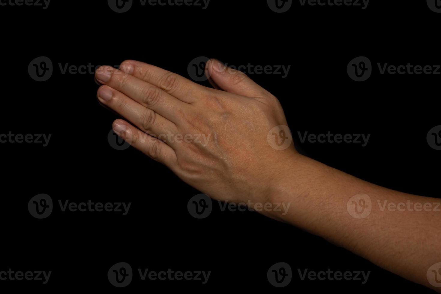 The man whose hand is praying on the black background photo