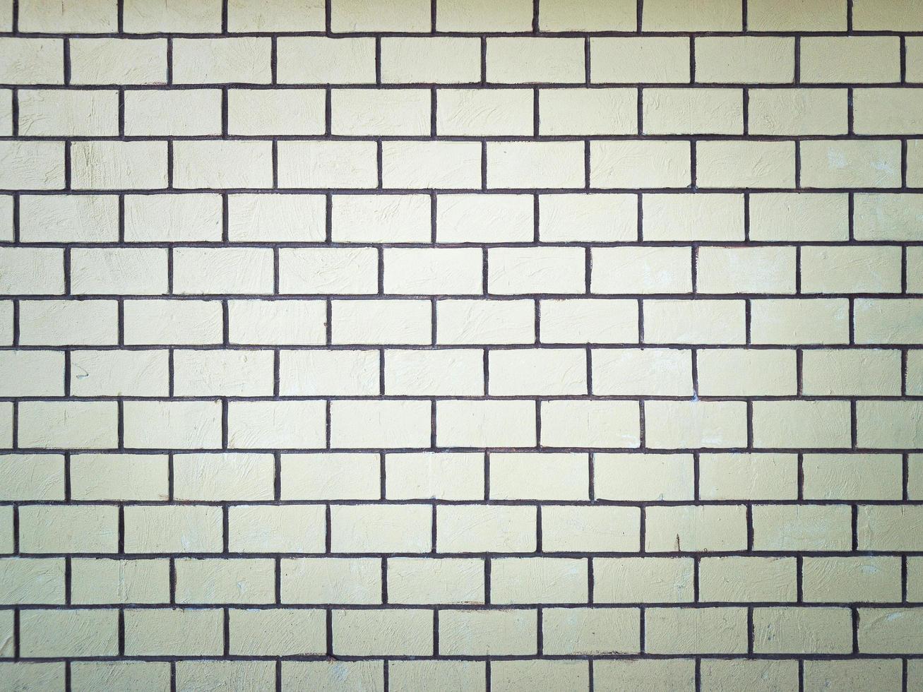 yellow brick wall with grunge background and vignetted. photo