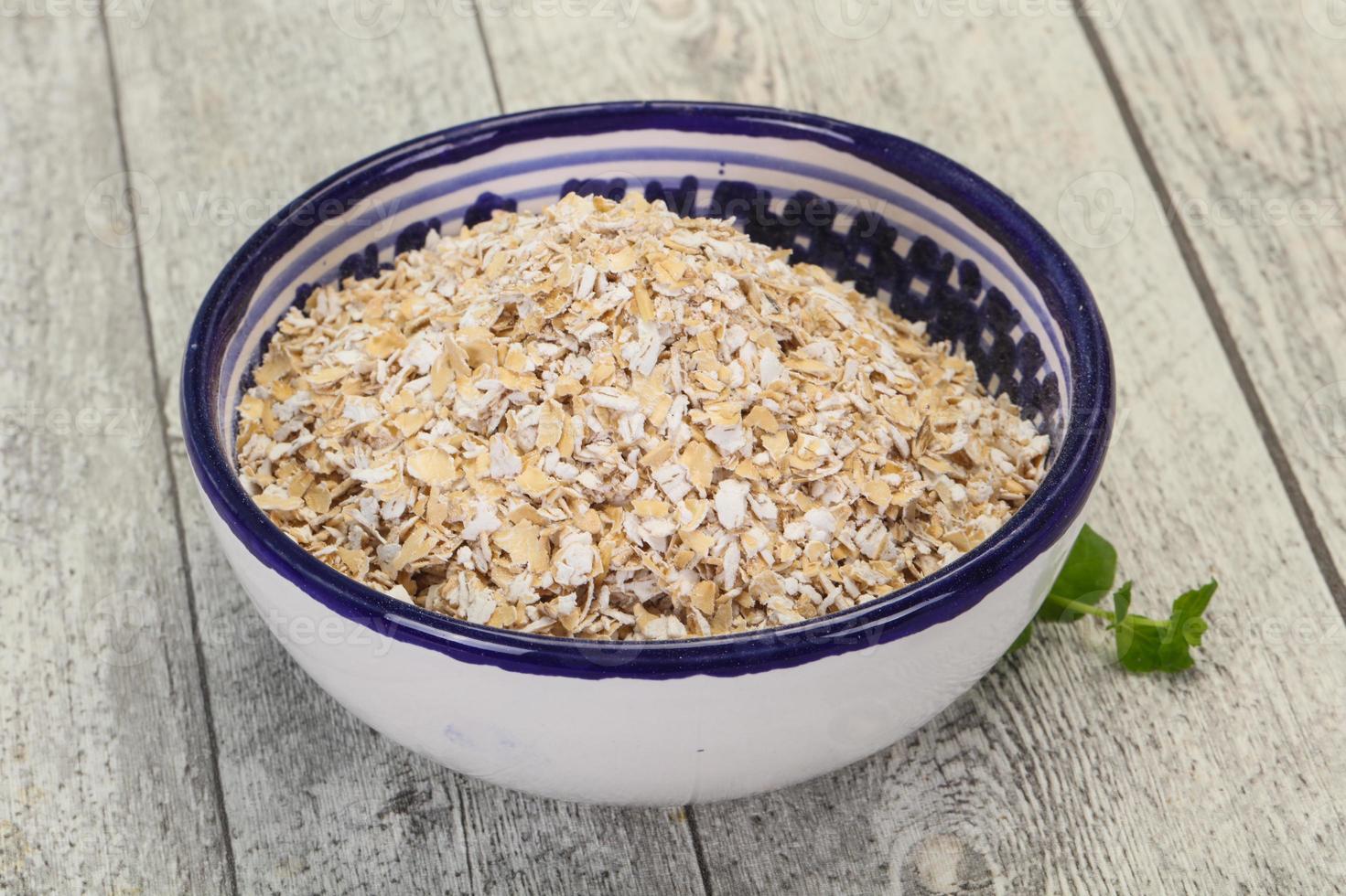 Raw oats in the bowl photo
