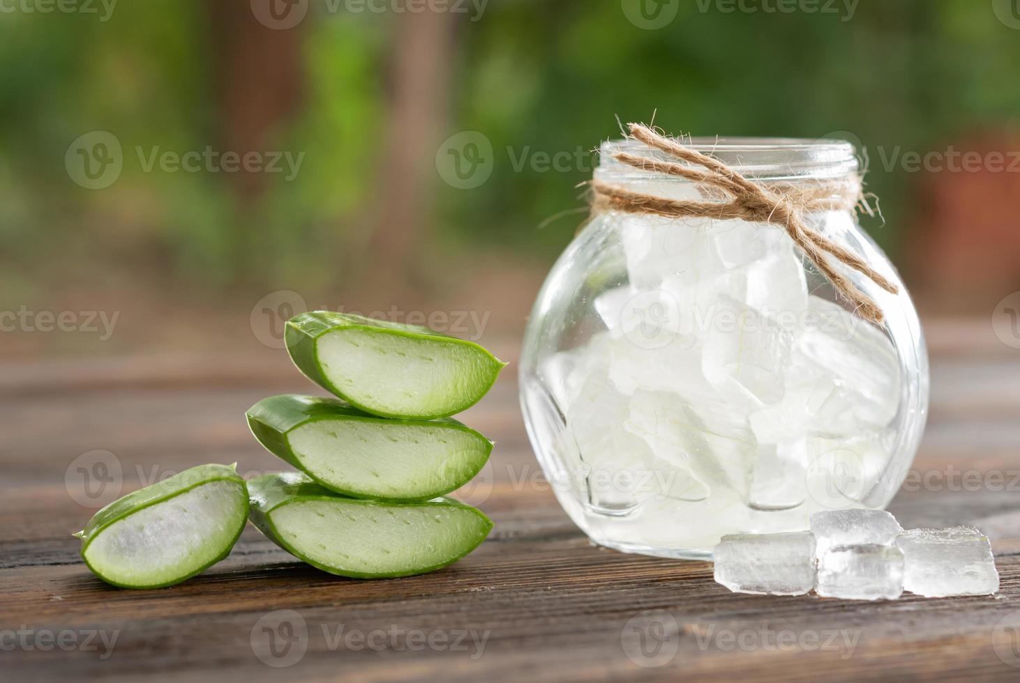 Aloe Vera on product display wood counter background. aloe vera is tropical green plants. Sliced Aloe Vera natural organic renewal cosmetics, alternative medicine. Organic Skin care concept. photo