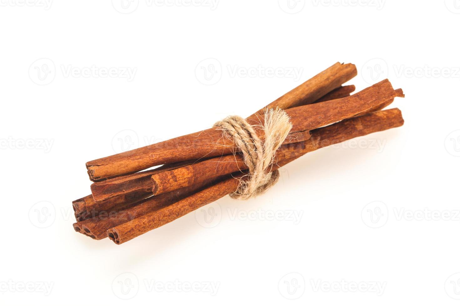 Cinnamon sticks heap isolated on white photo