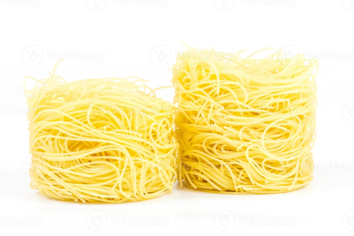 A portion of tagliatelle italian pasta isolated on white photo