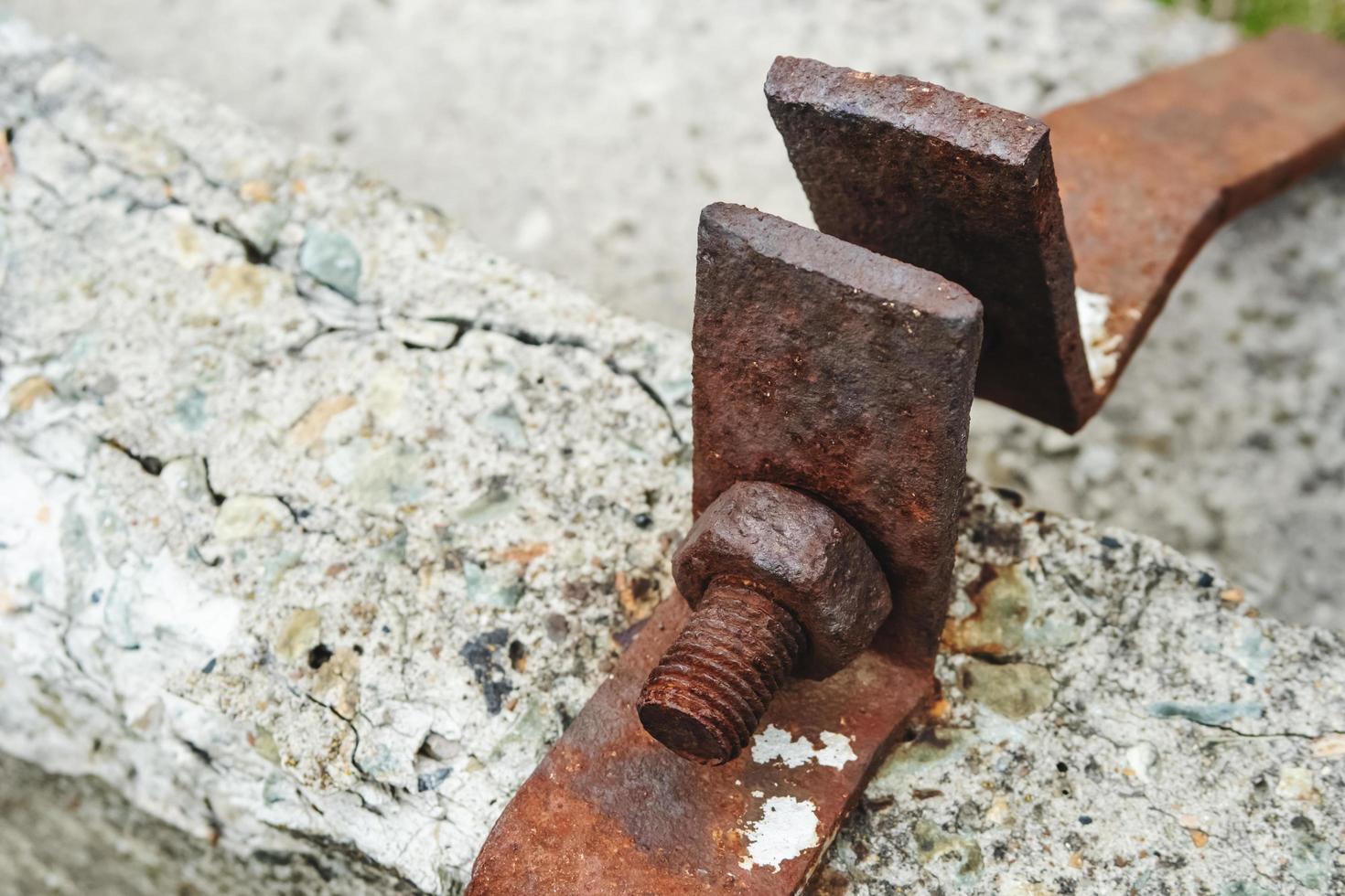 Rusty mounting brackets on a concrete block. photo