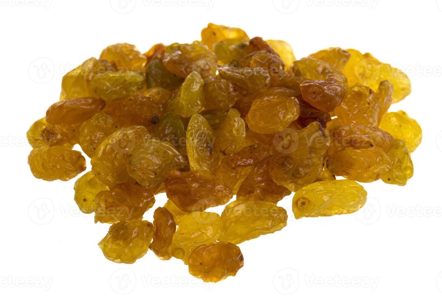 Golden raisins over white photo