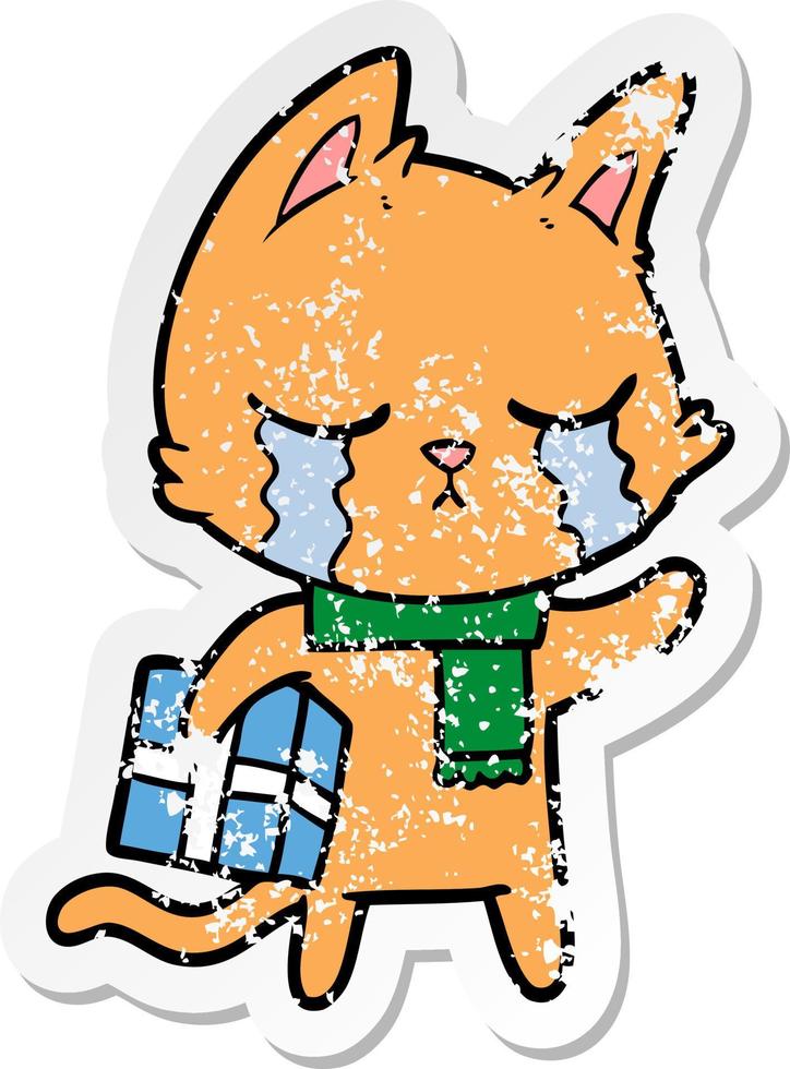 distressed sticker of a crying cartoon cat holding christmas present vector