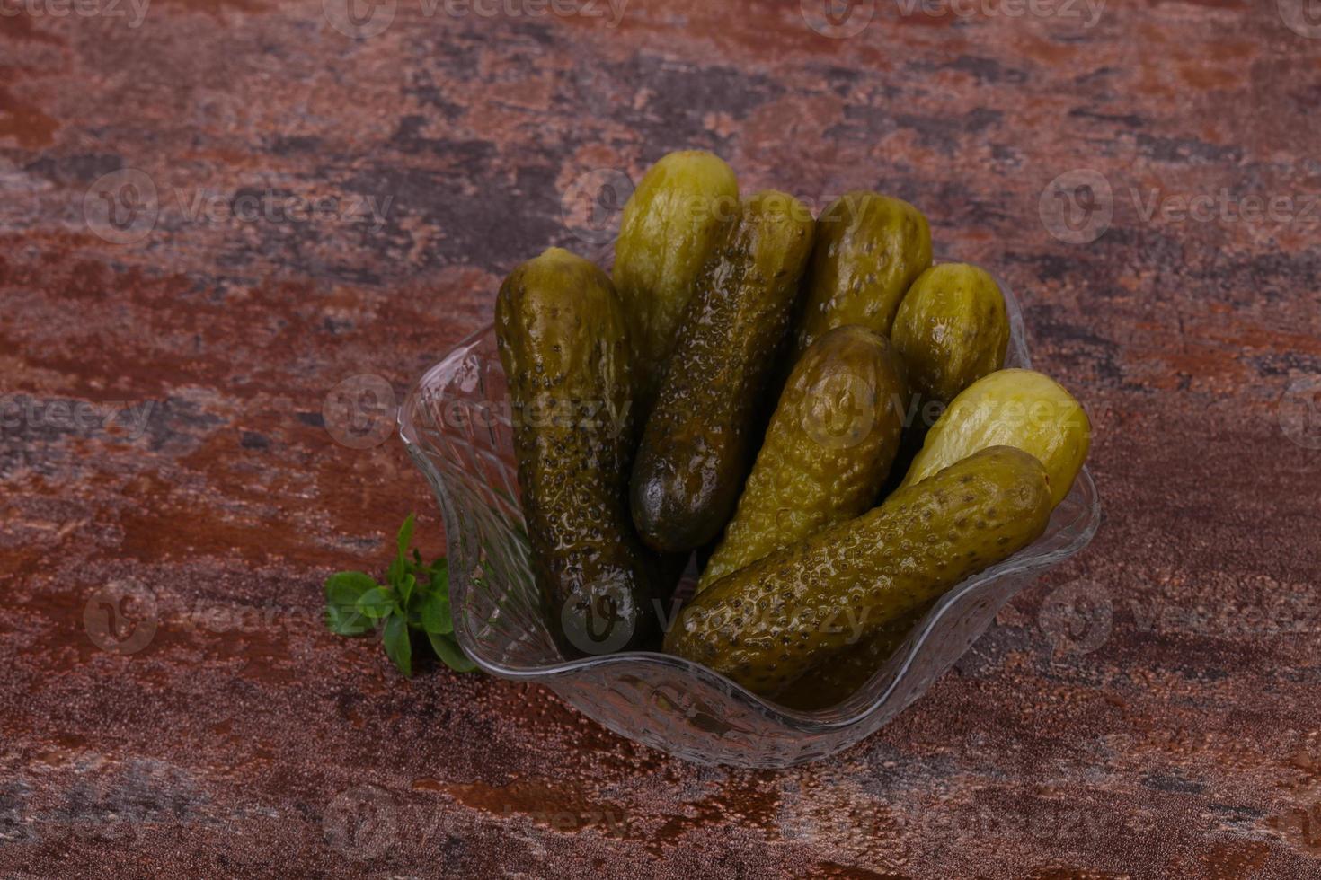 Pickled cucumbers heap in the bowl photo