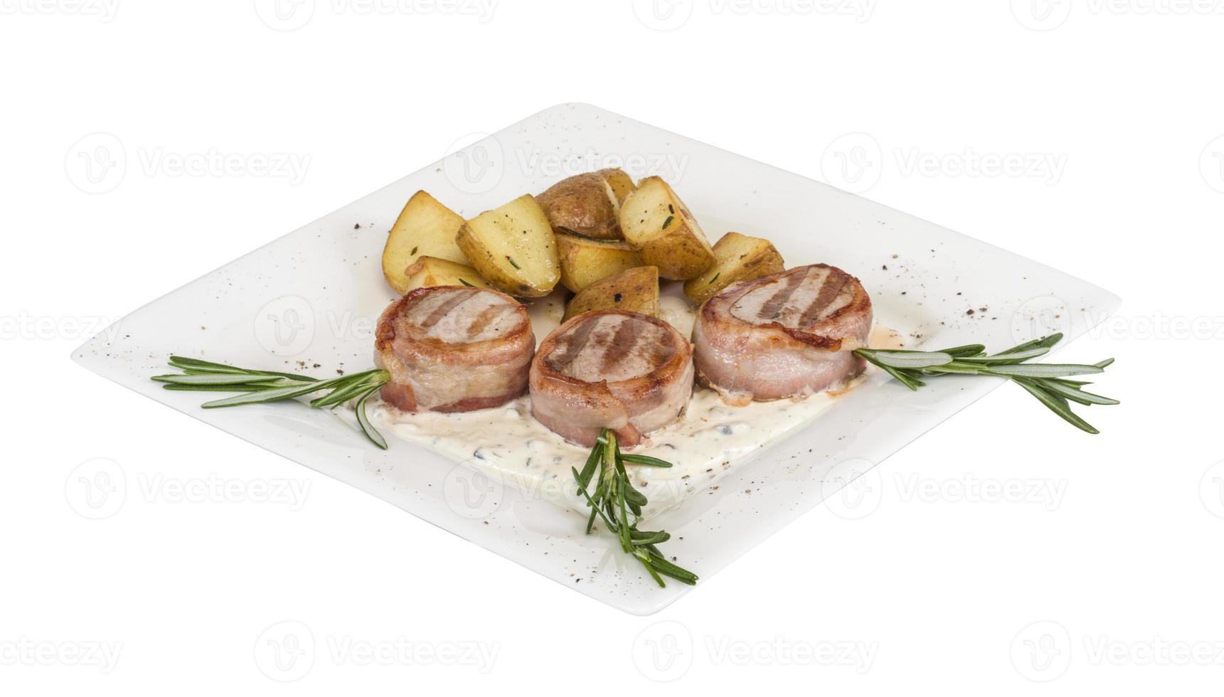 Grilled steak wrapped in bacon, with grilled vegetables, mashed potatoes photo