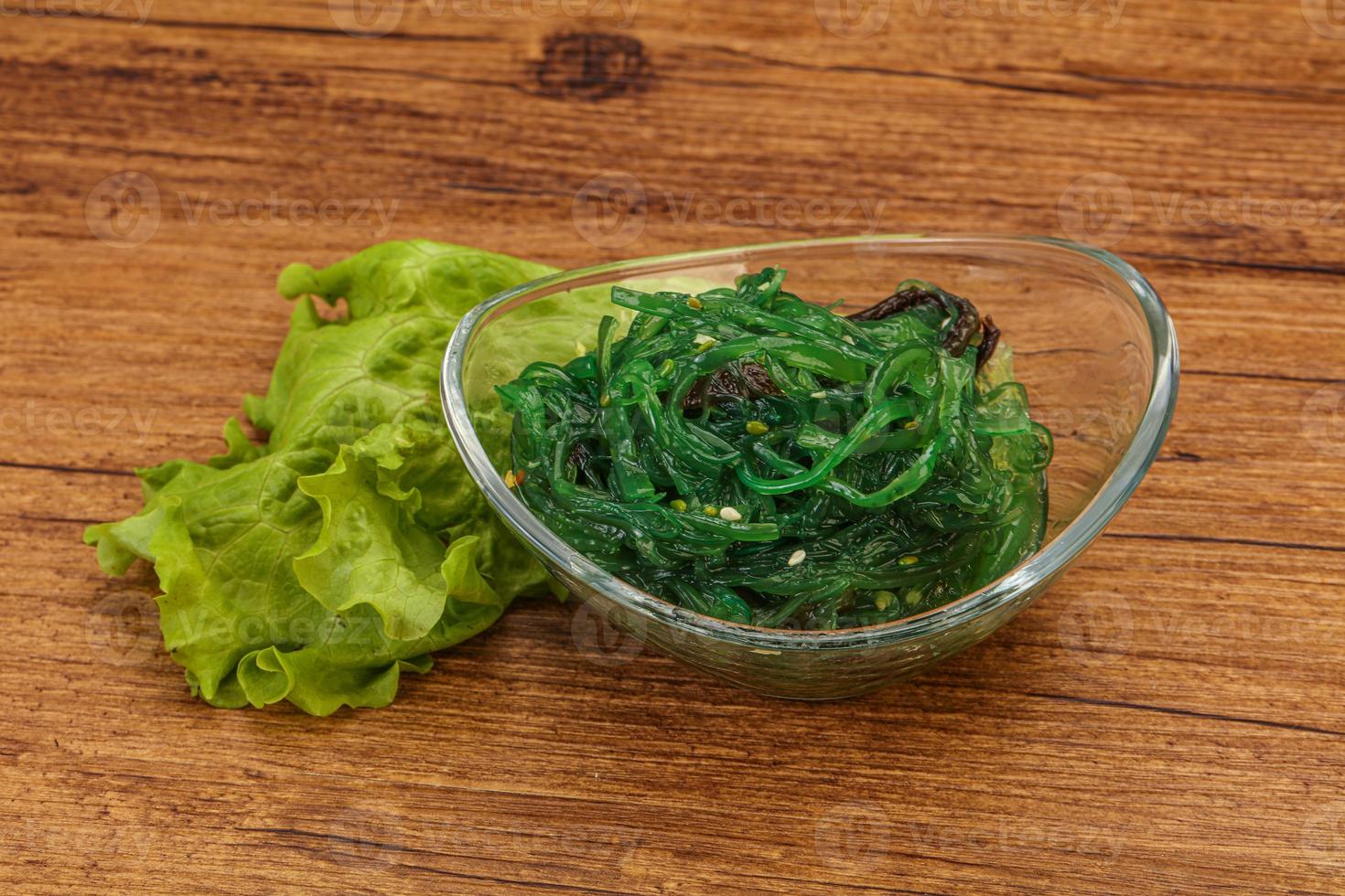 Green Chuka Seaweed Salad Isolated on White Background Top View. Wakame Sea Kelp Salat photo