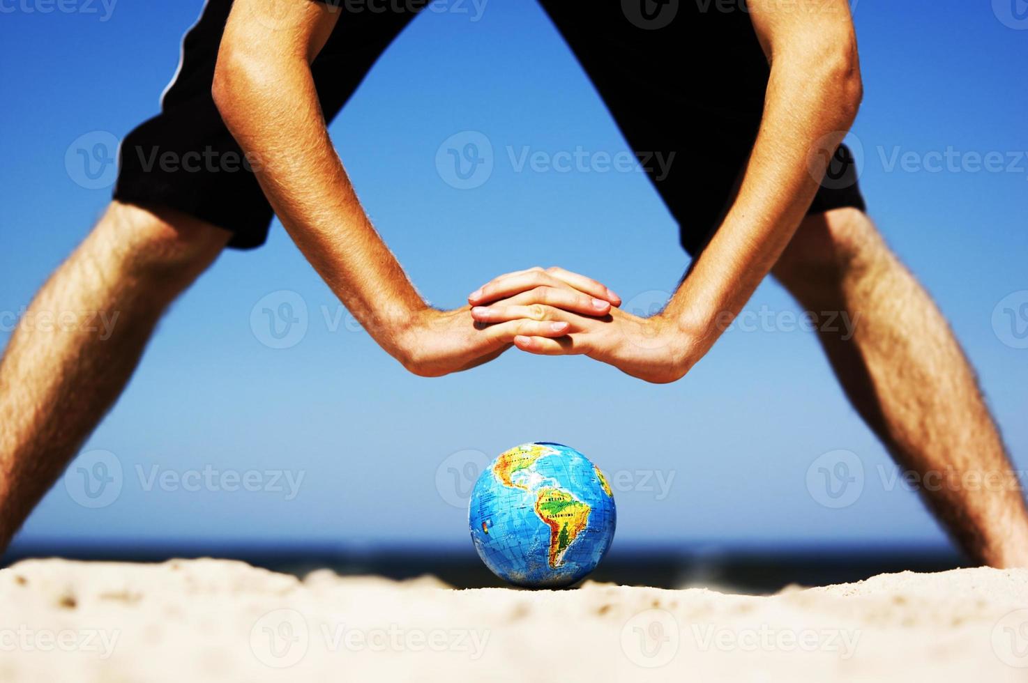 Earth globe with hands over it. Conceptual image photo