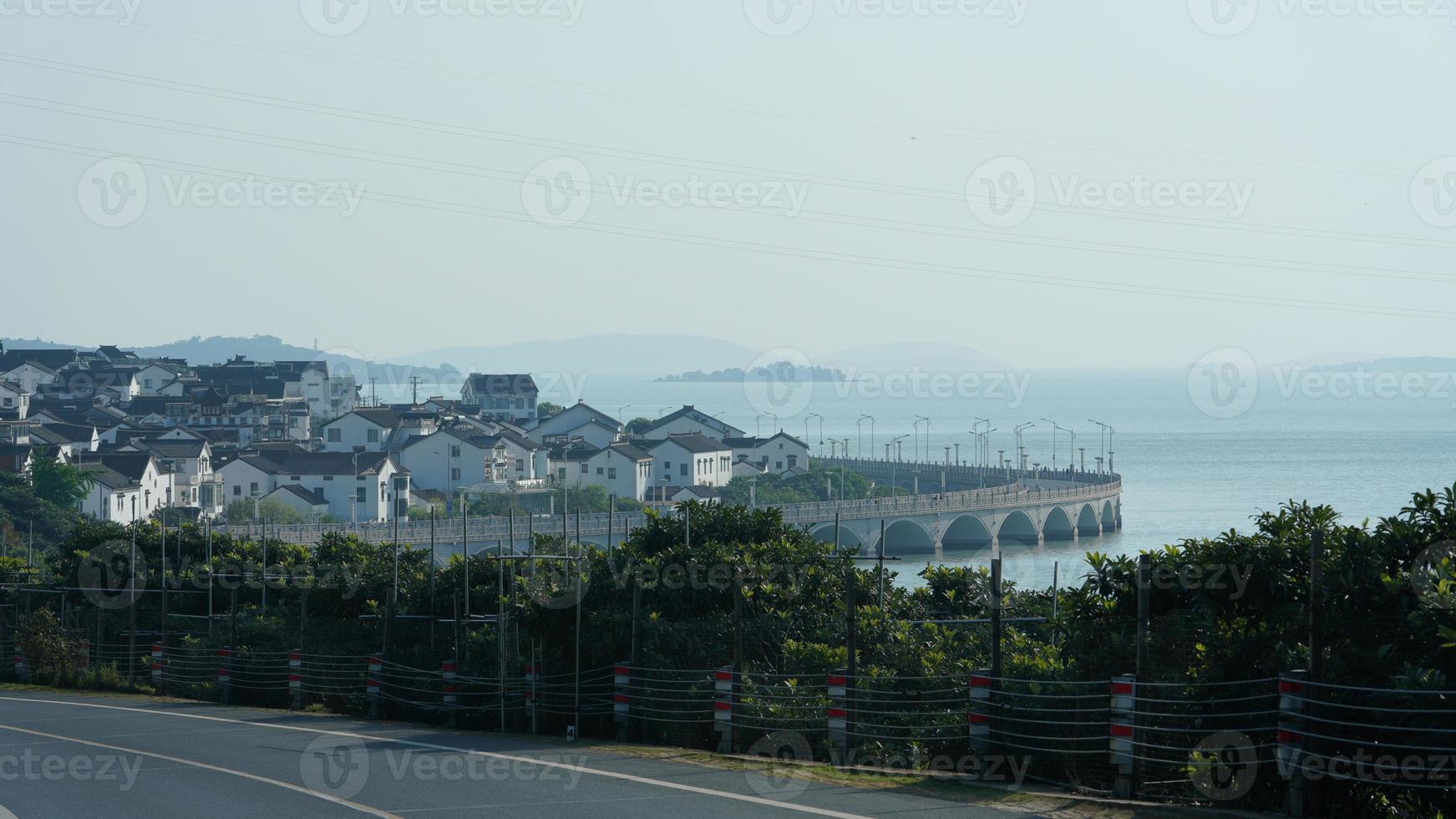 The beautiful Chinese countryside village view with  the old traditional buildings surrounded by the natural environment photo