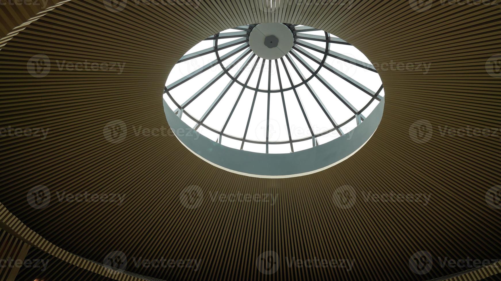 One buliding ceiling view with the sunligh into the building through the glass window photo