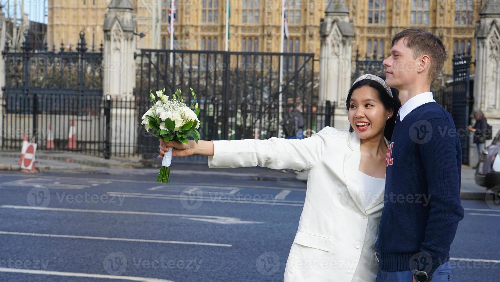 Newly married couple of different nationalities Out for a prewedding photoshoot in London. The man is British Asian women photo