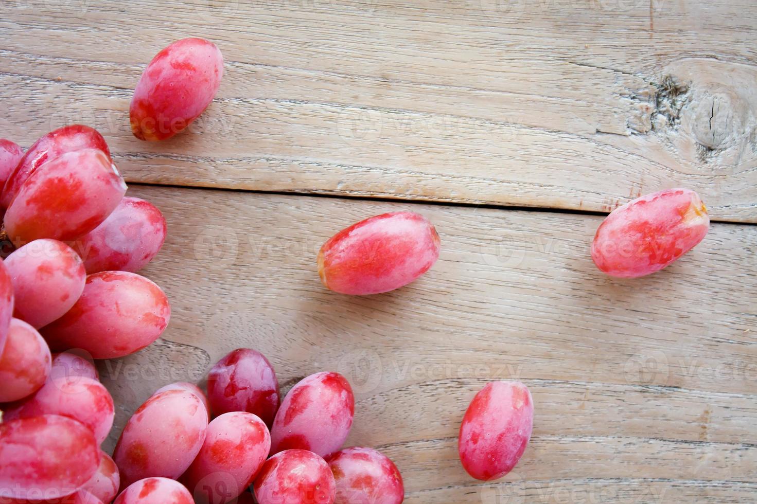 red grapes on wooden background photo