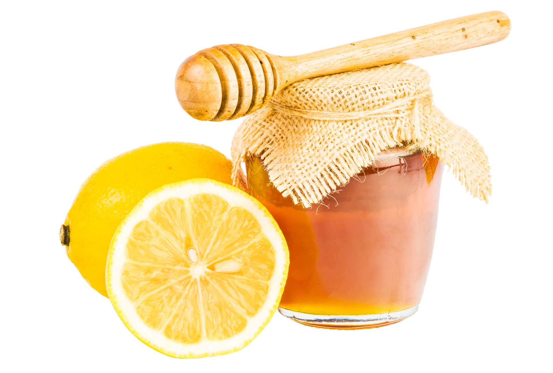 Glass jar full of honey wooden honey dipper and lemon on isolated