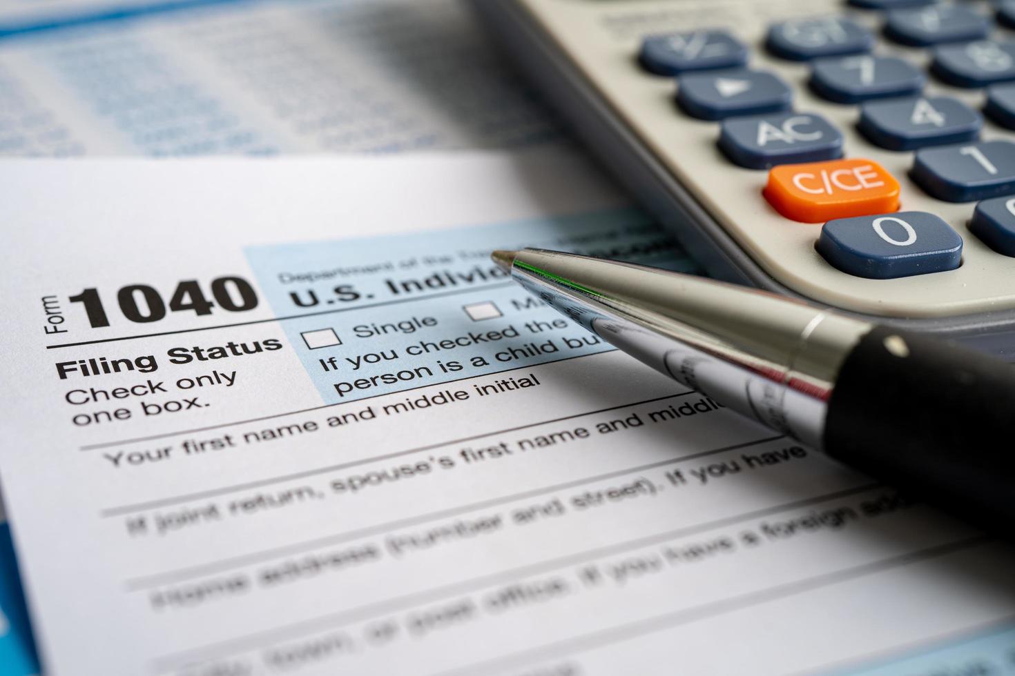 Tax Return form 1040 with USA America flag and dollar banknote, U.S. Individual Income. photo