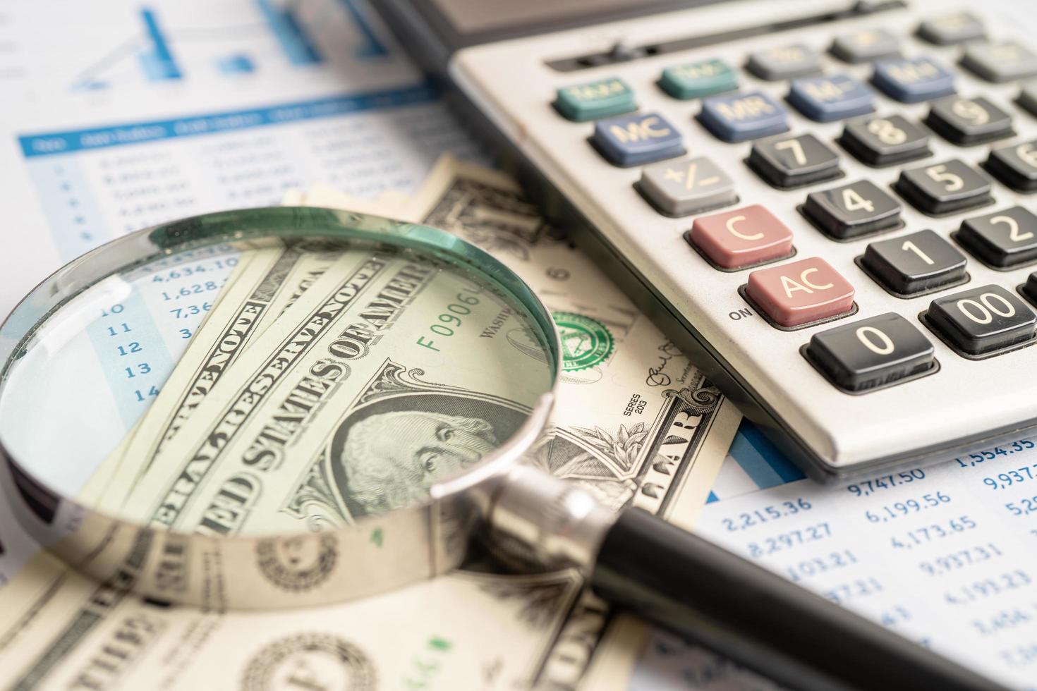 Magnifying glass on charts graphs paper. Financial development, Banking Account, Statistics, Investment Analytic research data economy, Stock exchange trading, Business office company meeting concept. photo