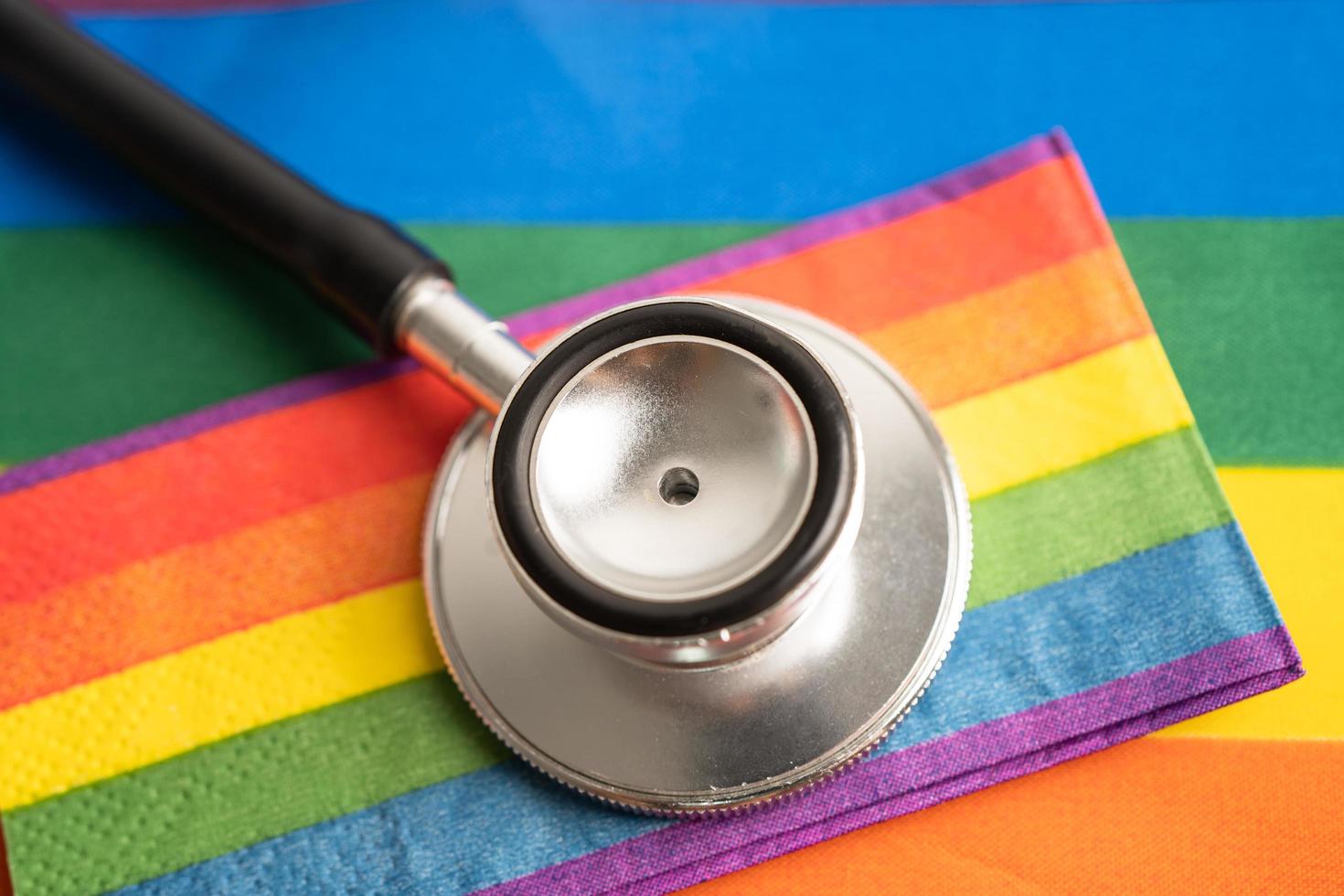 Black stethoscope with rainbow flag heart on white background, symbol of LGBT pride month  celebrate annual in June social, symbol of gay, lesbian, bisexual, transgender, human rights and peace. photo