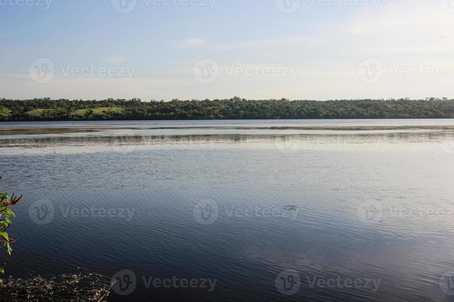 Landscape of the Dnieper River, Zaporozhye region. Ukraine. Summer view of the river in green trees, wildlife, nature reserve, clear blue sky photo