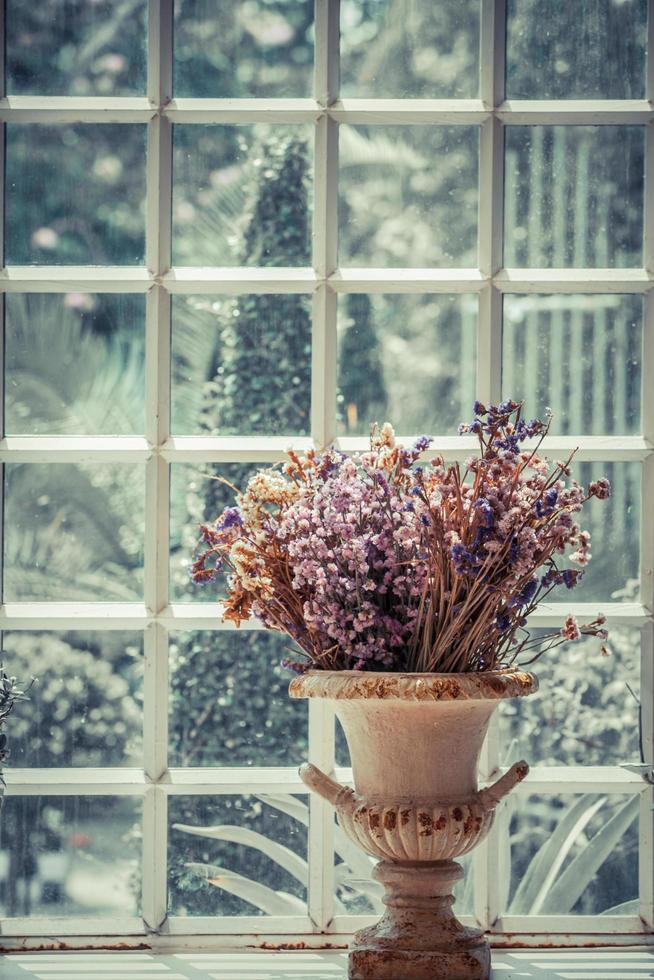 vase of dried flowers located by the window.soft focus.vintage style. photo