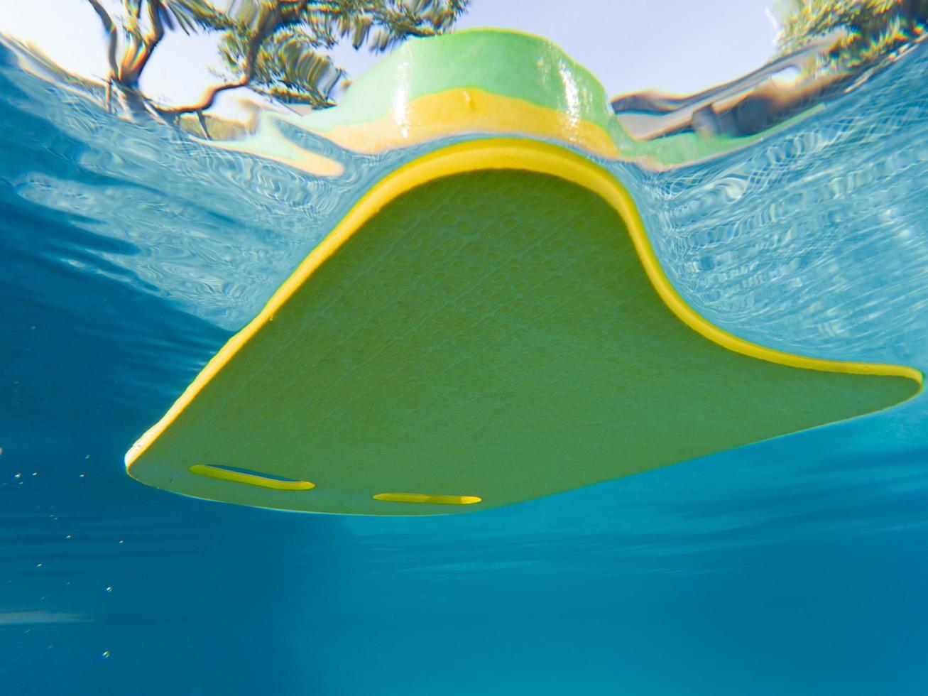 Swimming board Yellow-green Floating in the pool photo