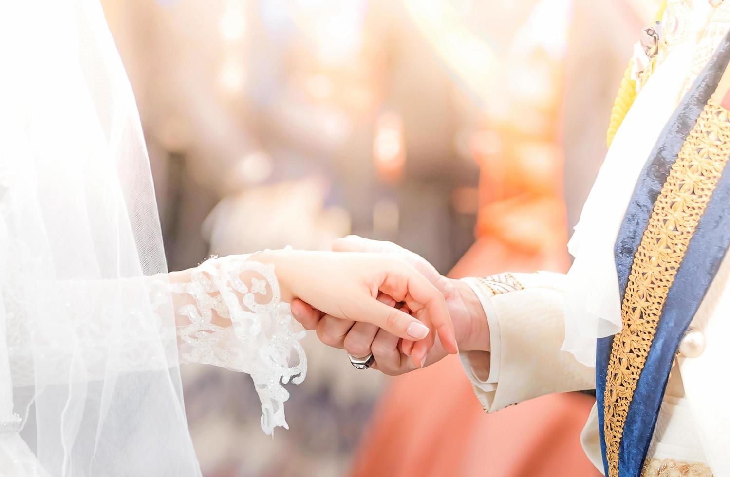 Couple in love holding hands on blurred  background ,Vintage style picture.Happy bride and groom holding hands and walking in field on wedding day.soft focus. photo