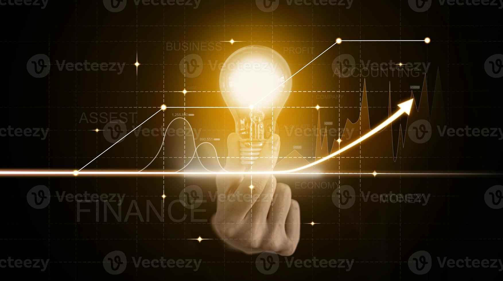 The person holding an orange light bulb, graphic charts and fluctuations in financial data, showing business growth. Business strategy. Digital marketing. digital business hologram. photo