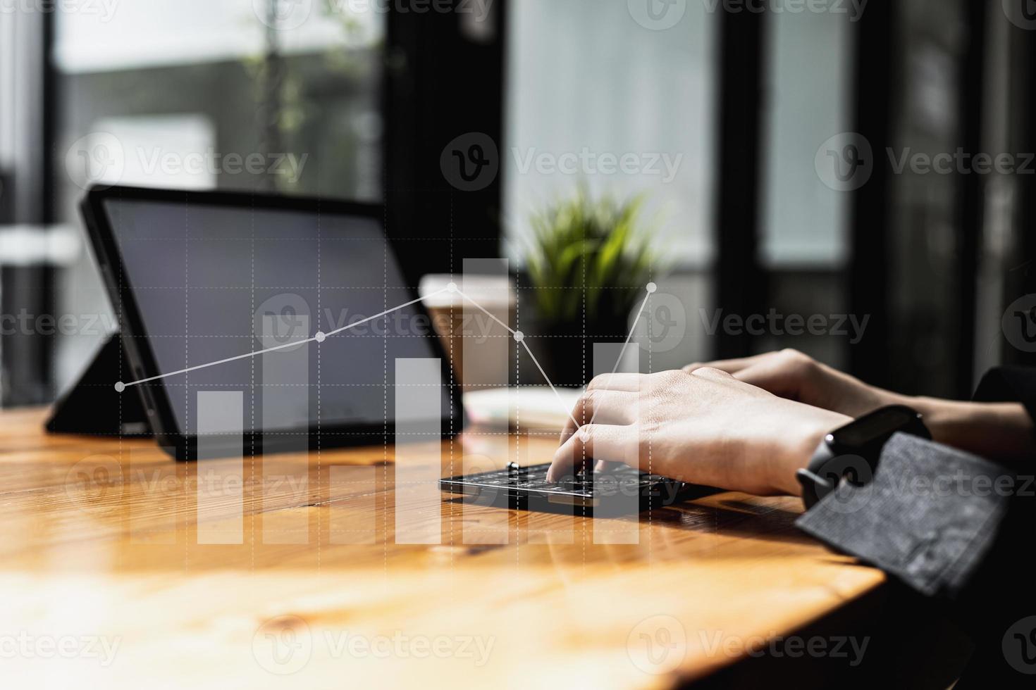 Person typing on tablet keyboard, bar chart graphs Line chart showing financial growth. Image of the concept of financial management and capital development for growth. Digital Finance. photo