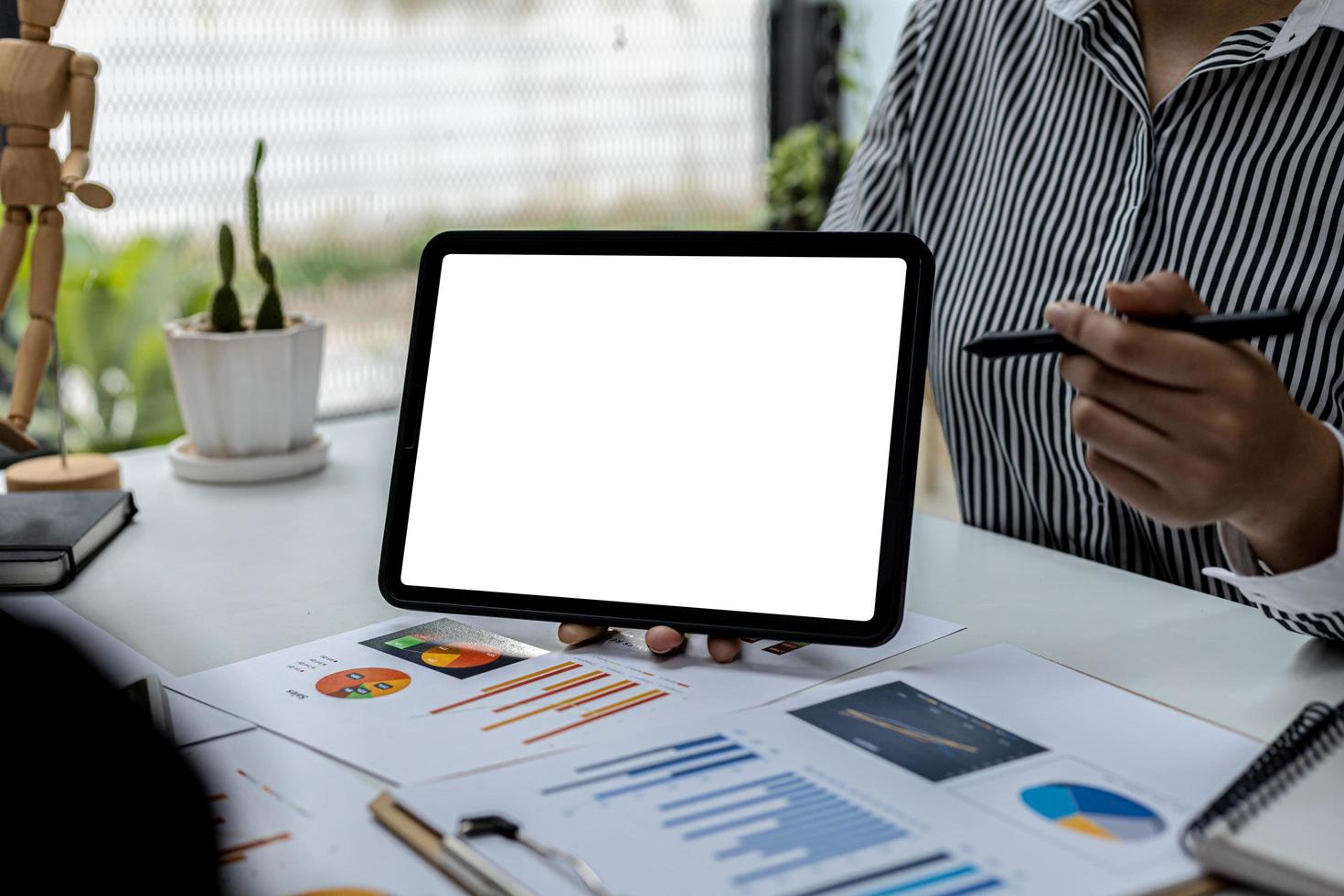 Person holding a tablet and having a meeting, on a blank white background tablet screen for illustration, mockup screen for further editing can be used for a variety of tasks. copy space. photo
