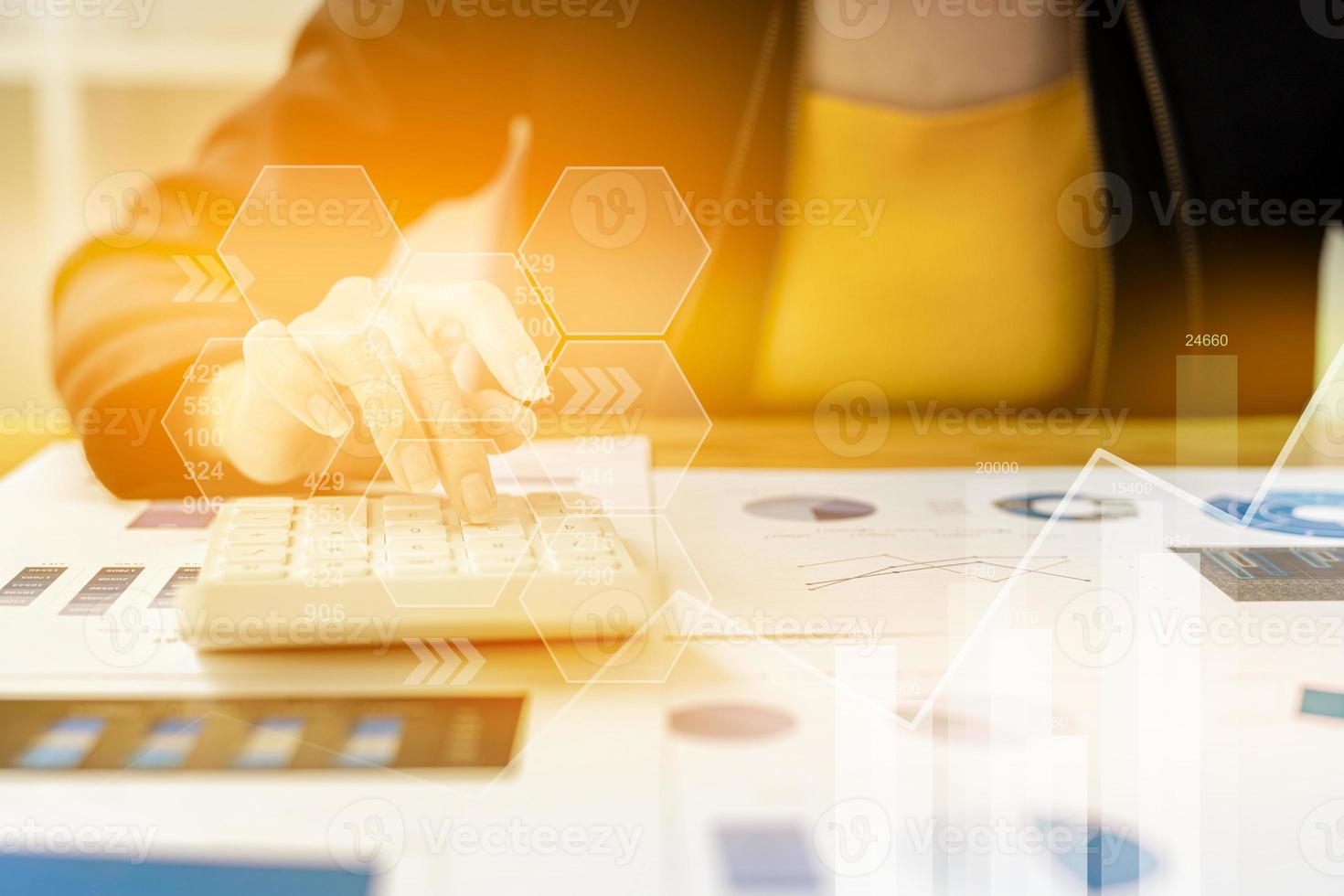 Businesswoman presses a calculator to check data on documents, company financial reports, graphics showing financial and numerical growth data. Financial management to grow and be a profitable concept photo