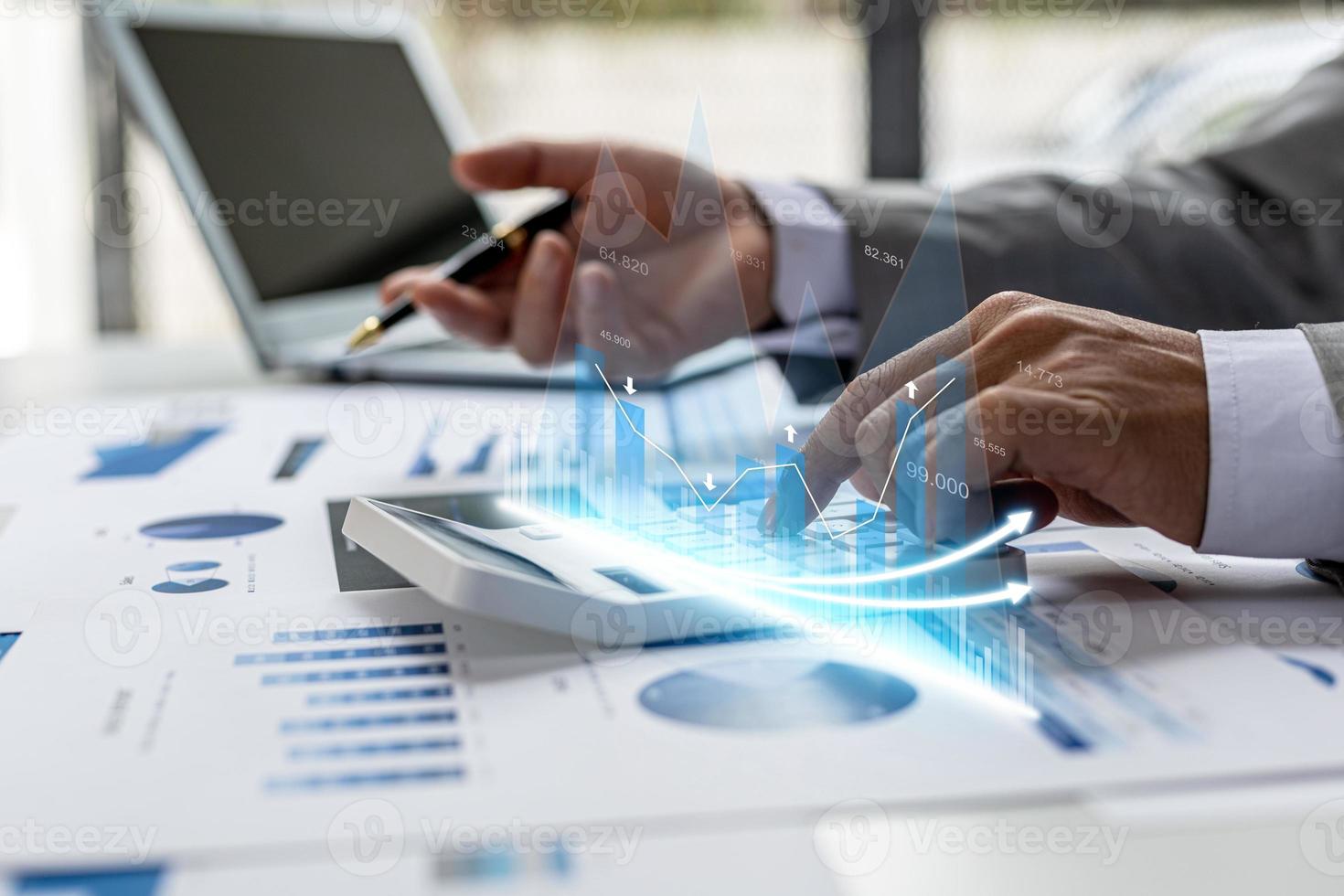 Businesswoman presses a calculator to check data on documents, company financial reports, graphics showing financial and numerical growth data. Financial management to grow and be a profitable concept photo