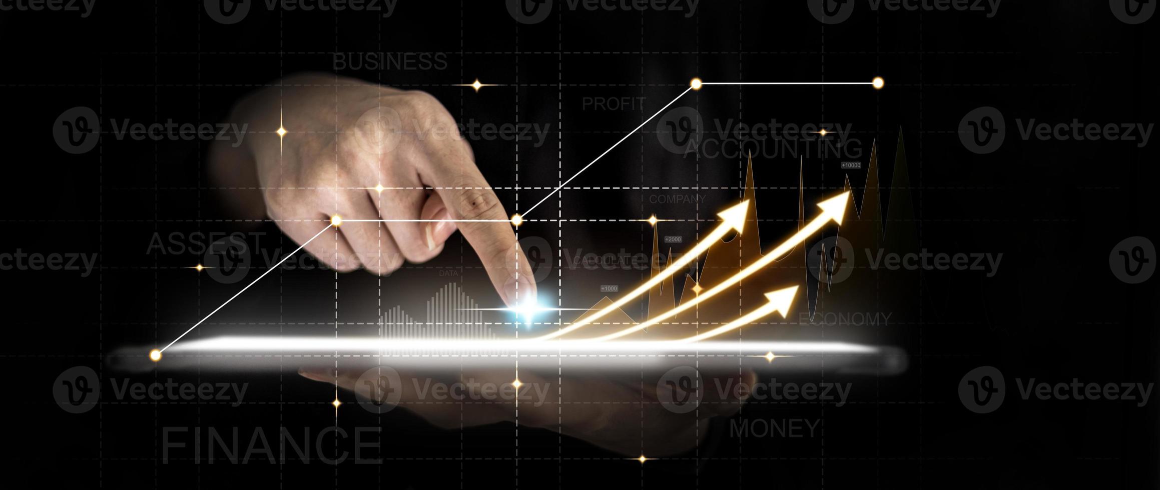 Person holding a tablet and pointing finger at the screen, graphic charts and fluctuations in financial data, showing business growth. Business strategy. Digital marketing. digital business hologram. photo