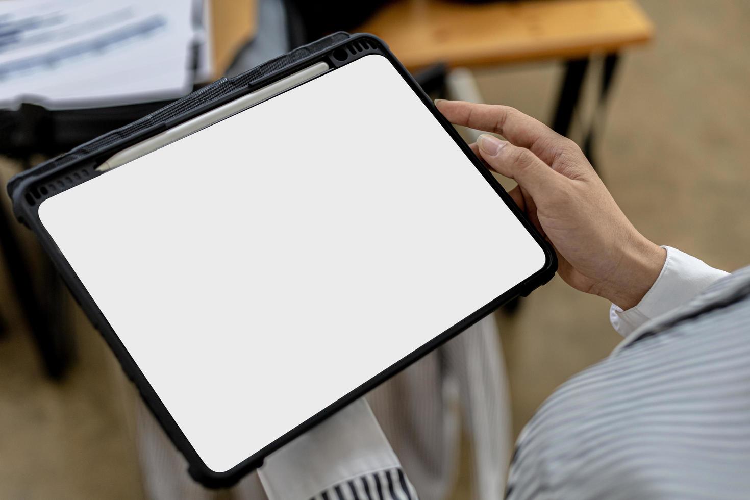 Blank screen of tablet, person holding tab and looking at blank tablet screen, mockup screen for further editing can be used for a variety of tasks. copy space. photo
