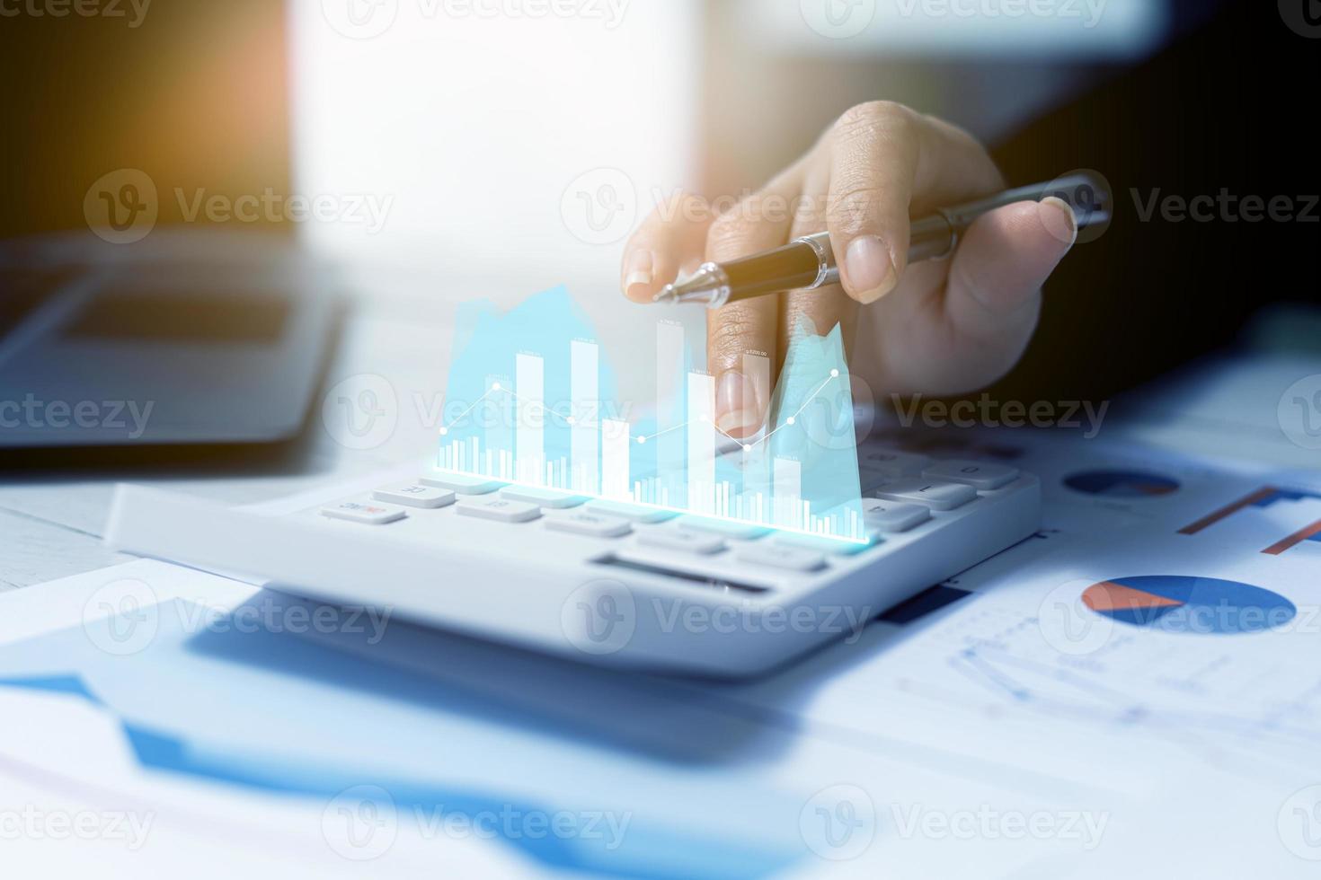 A business man examines data on financial documents, company financial reports, graphics showing financial and numerical growth data. The concept of financial management to grow and be profitable. photo