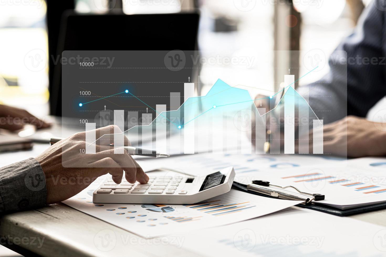 Two businessmen are meeting together, they point to financial documents to discuss plans and solutions, chart graphics showing financial status and performance. Business administration concept. photo