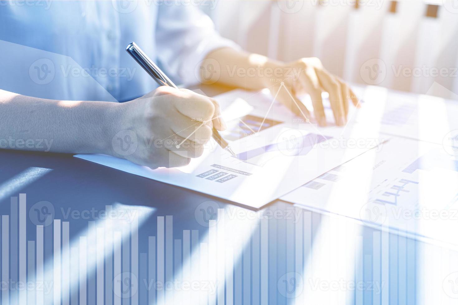 A businesswoman examines data on financial documents, company financial reports, graphics showing financial and numerical growth data. The concept of financial management to grow and be profitable. photo