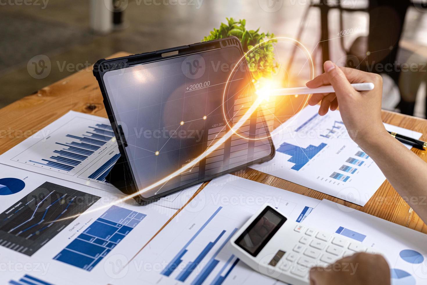 A business man examines data on financial documents, company financial reports, graphics showing financial and numerical growth data. The concept of financial management to grow and be profitable. photo